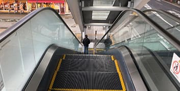 Take an escalator downward